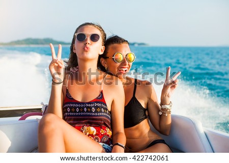 Hipster girl, speed boat, Glamorous tanned Model in fashionable Swimsuit and stylish. sexy tanned slim body, wet skin