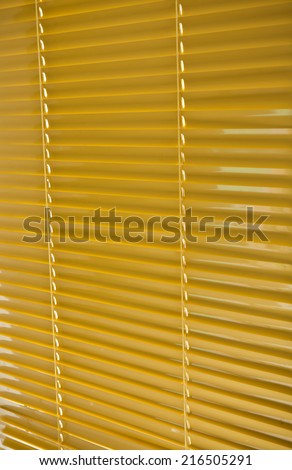 Colored yellow plastic blinds closed