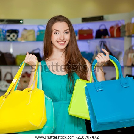 Beautiful girl in a store shopping bags. Shopping