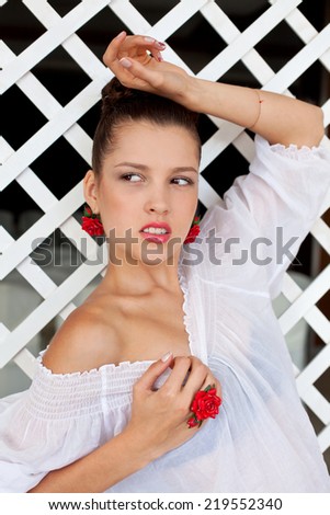 Beautiful girl with red earrings and ring