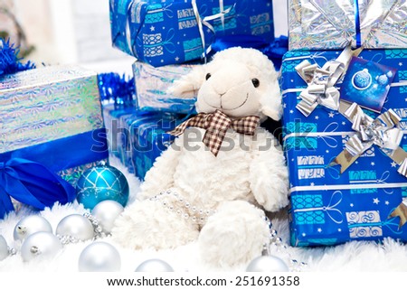 Many blue boxes of Christmas gifts and decorative interior goat in the New Year