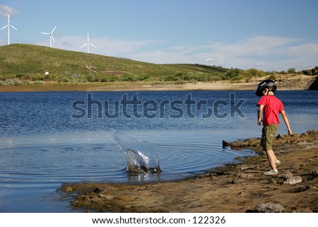 Children throwing stones to the lake