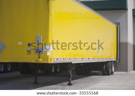 Yellow Semi Trailer parked in loading dock