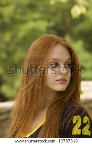 Beautiful teen looking over her left shoulder off into the distance