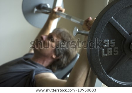man bench pressing heavy weight