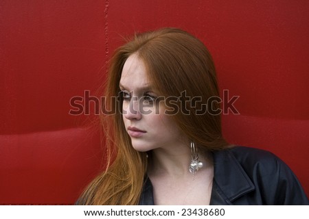 beautiful red head with a red back ground