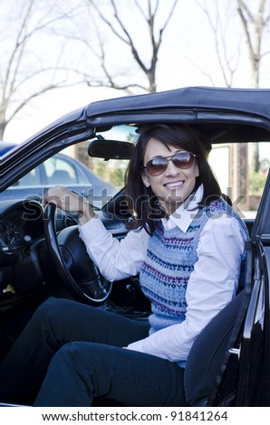 attractive woman stepping out of her car