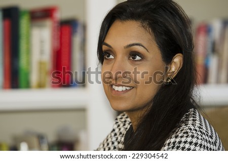 Pretty young Indian woman in conversation with someone