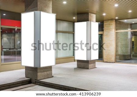 Mock up of two vertical lightboxes in city space at night