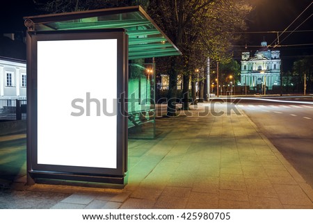 Mock up of blank bus stop vertical advertising light box at night