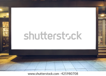 Mock up of store blank street showcase window in a city at night. Front view