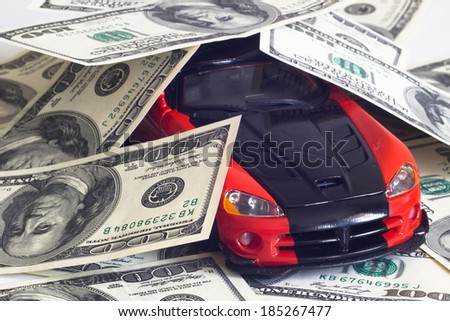 toy sports car on a background of money