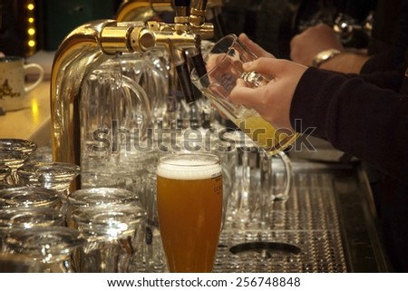 Barman pouring beer