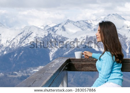 Beautiful Woman Joyful Cup of Tea on Snow Mountains Background