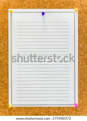 White paper with line pinned on cork board with colored pin for education and business