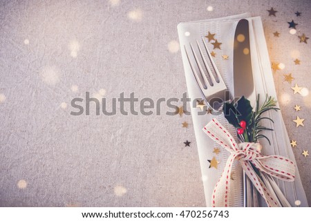 Christmas table place setting, copy space fairy light toning background
