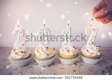 2017 Happy New Year Cupcakes with fairy light toning background