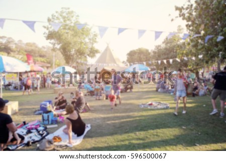 Blur defocused background of people in park fair, summer festival, toning