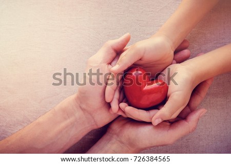 adult and child hands holding red heart, health care love, give, hope and family concept, world heart day,world health day