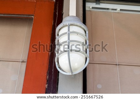 Old electric outdoor house lamp on wall