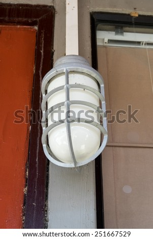 Old electric outdoor house lamp on wall