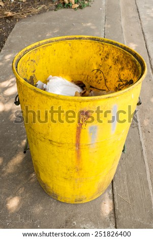 junk in yellow garbage bins