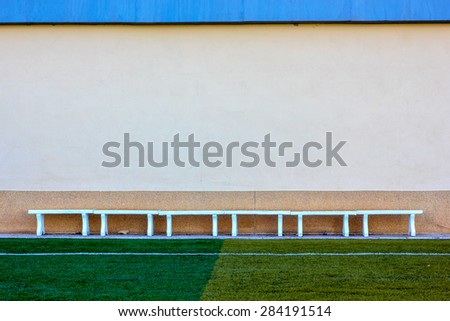 concrete bench in sport stadium and abstract grunge wall. Copyspace for your text. For presentation.