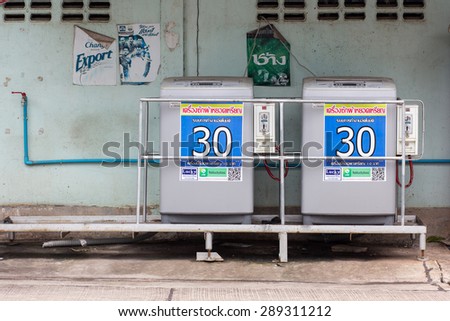 Udonthani, Thailand - June 21, 2015: In Thailand Public Laundry Washing Machines can see on street for people used them. Public Laundry Washing Machines with Closed Doors.