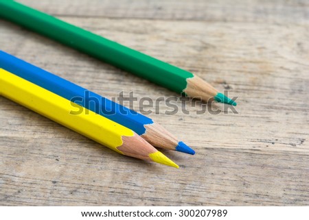 Color pencils on wood background close up ,Color pencils Background texture ,Color pencils yellow mix blue to green color,primary color