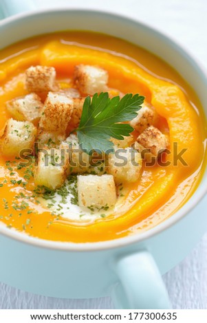 Pumpkin soup with croutons and Italian parsley