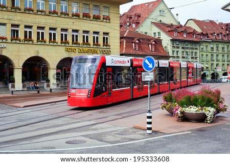 BERN, SWITZERLAND - AUGUST 24: Red town tram on the Casinoplatz central square on August 24, 2012 in Bern, Switzerland.