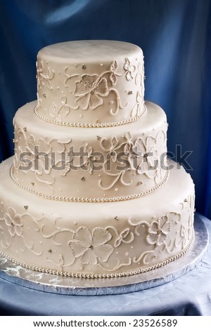 stock photo Elegant ivory wedding cake with a piped embroidered lace 