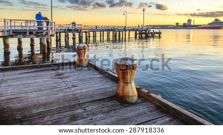 city pier fishing sun setting