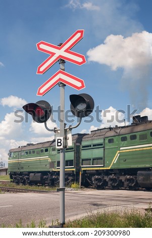 Railroad crossing with passing freight train