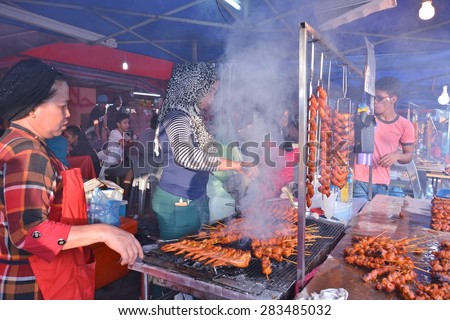 SABAH, MALAYSIA - MAY 31, 2015 : Unidentified people sells roasted chicken wings at KDCA Food Stall Market during the grand Harvest Festival on May 31, 2015 in Kota Kinabalu, Sabah Borneo, Malaysia.
