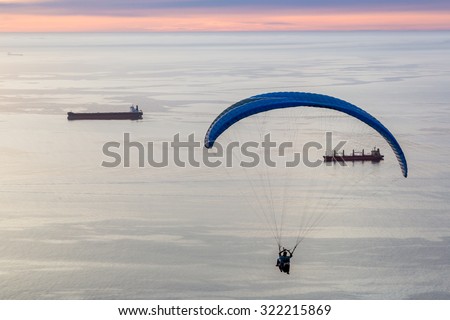 Tourists enjoying paraglide jump from the lions mountain in Cape Town, South Africa