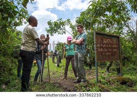 Virunga National Park, DR.Congo - October 7th 2015 - A group of tourist, rangers and carriers inside the tropical jungle heading to the Nyarogongo Crater in DRC, Central Africa.