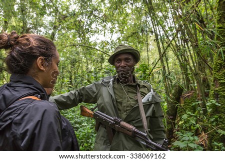 Virunga National Park, DR.Congo - October 5th 2015 - A ranger equipped with a AK-47 leads a group of tourist through the jungles, inside the Virunga National Park in DRC, Central Africa.