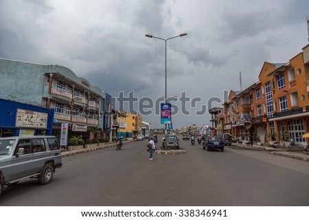 Goma City, DR CONGO - October 5th 2015 - Local people driving in a wet day in the streets of Goma in DR Congo, Central Africa.