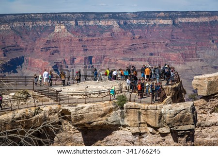 Grand Canyon, Arizona - March 21st 2014 - Big group of people from different countries enjoying a sunny day at the south rim of the Grand Canyon National Park, Arizona, USA