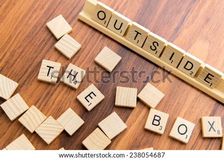December 14, 2014 - Houston, Texas, USA - illustrative editorial of Scrabble tiles spelling OUTSIDE THE BOX