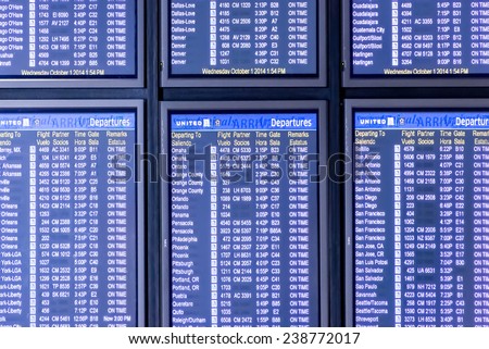October 1, 2014:IAH, Houston Intercontinental Airport, Houston, TX, USA - flight information display screens in airport