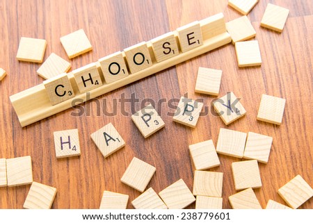 December 14, 2014: Houston, TX, USA - Scrabble tiles spelling CHOOSE HAPPY