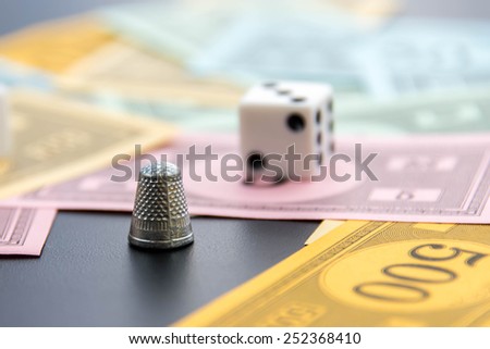 February 8, 2015 - Houston, TX, USA.  Monopoly thimble, dice and money