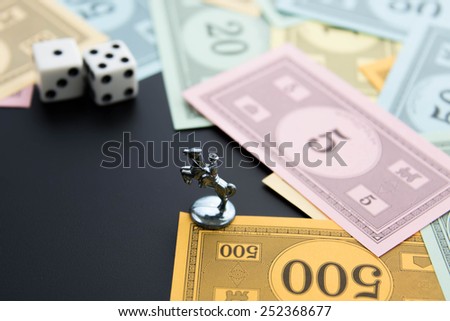 February 8, 2015 - Houston, TX, USA.  Monopoly horse, dice and money