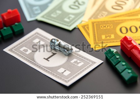 February 8, 2015 - Houston, TX, USA.  Monopoly car, money, hotels and houses