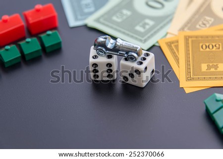 February 8, 2015 - Houston, TX, USA.  Monopoly car, dice, money, hotels and houses