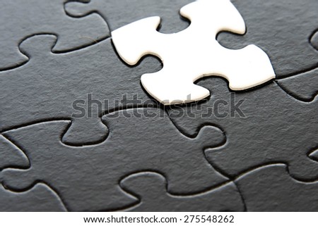 black and white puzzle pieces contrasting