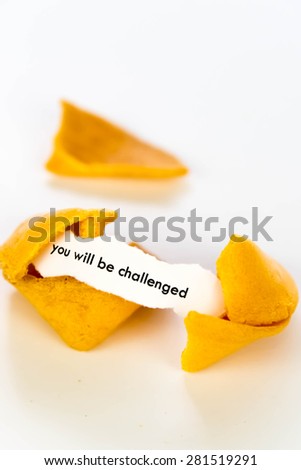 open fortune cookie with strip of white paper - YOU WILL BE CHALLENGED