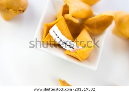 open fortune cookie with strip of white paper - YOU HAVE NO LIMITATIONS